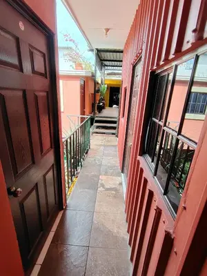 a hallway of a building with a door at Rooms libertad in San Salvador