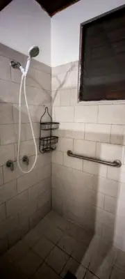 a shower with a shower head in a bathroom at Habitación Lomas de San Francisco in San Salvador