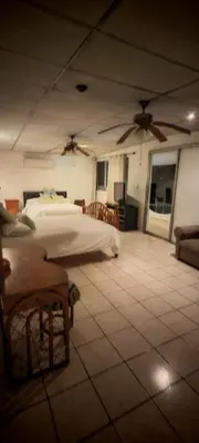 a large room with two beds and a couch at Habitación Lomas de San Francisco in San Salvador