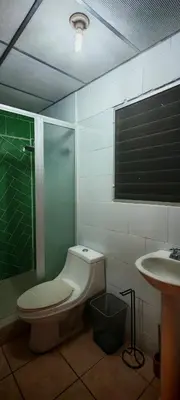 a bathroom with a toilet and a shower and a sink at Habitación Lomas de San Francisco in San Salvador