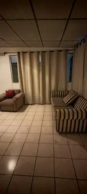 a large room with two beds and a couch at Habitación Lomas de San Francisco in San Salvador