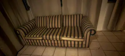 a couch sitting in the corner of a room at Habitación Lomas de San Francisco in San Salvador