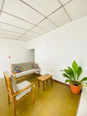 a living room with a couch and a table at Hostal La casa de Ross in Santa Ana