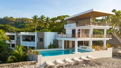 a house on the beach with a swimming pool at 2Surf Sunzal in El Sunzal