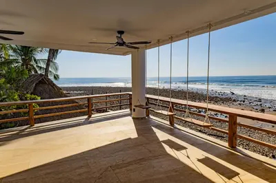a balcony with a view of the beach at 2Surf Sunzal in El Sunzal
