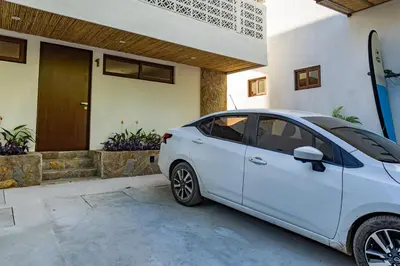 a white car parked in front of a house at 2Surf Sunzal in El Sunzal