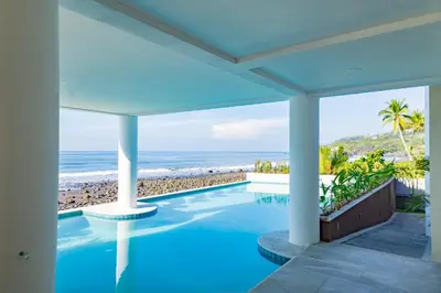 a swimming pool with a view of the beach at 2Surf Sunzal in El Sunzal