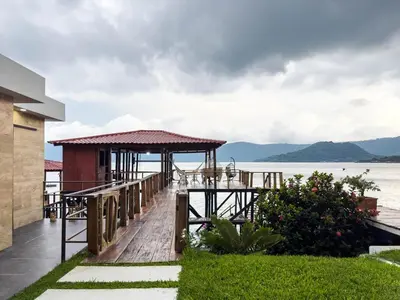 a wooden dock with a gazebo next to the water at Quinta Avanti Villa-Coatepeque Lake-14 guest in Santa Ana