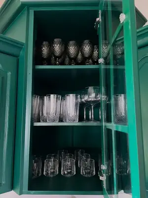a green cabinet with glasses in it at Quinta Avanti Villa-Coatepeque Lake-14 guest in Santa Ana