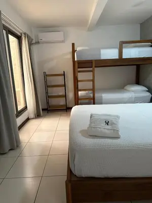 a bedroom with two bunk beds and a tiled floor at Quinta Avanti Villa-Coatepeque Lake-14 guest in Santa Ana