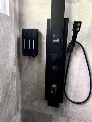 a black phone in a shower in a bathroom at Quinta Avanti Villa-Coatepeque Lake-14 guest in Santa Ana