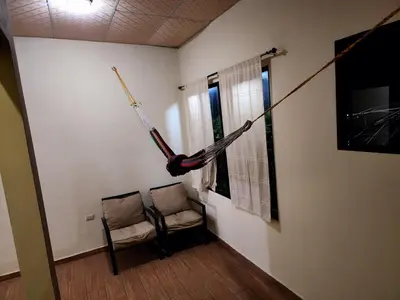 a room with a hammock hanging on the wall at House Moma