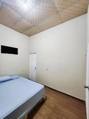 a bedroom with a bed and a white wall at House Moma