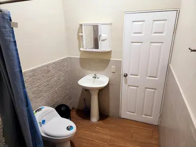 a small bathroom with a toilet and a sink at House Moma
