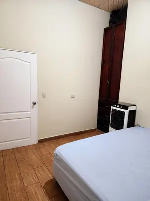a bedroom with a bed and a cabinet and a microwave at House Moma