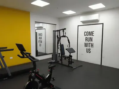 a gym with bikes and a sign that says come run with us at Apartamento YOU D6 in San Salvador