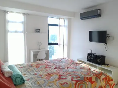 a bedroom with a bed and a flat screen tv at Apartamento YOU D6 in San Salvador