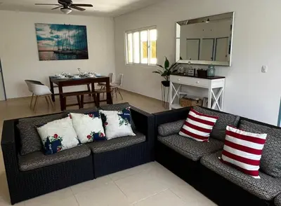 a living room with two couches and a table at Sunsets Apartment in San Luis La Herradura