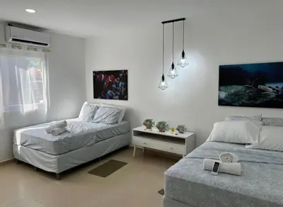 a bedroom with two beds and a night stand at Sunsets Apartment in San Luis La Herradura