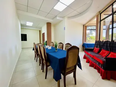 a dining room with a blue table and chairs at Hotel D' Palacio Real in San Miguel