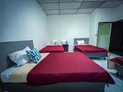 a bedroom with two beds with red sheets and a mirror at Hotel D' Palacio Real in San Miguel