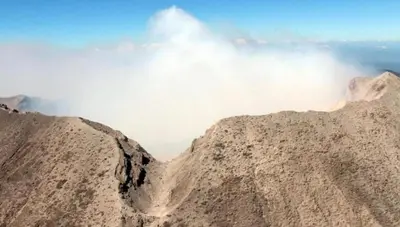 a view of the top of a mountain with clouds at Hotel Caleta in San Miguel