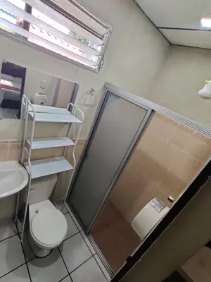 a bathroom with a shower and a toilet and a sink at Hotel en Santa Ana in Santa Ana