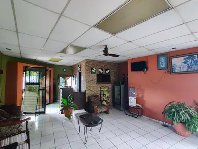 a living room with orange walls and a white tile floor at Hotel en Santa Ana in Santa Ana