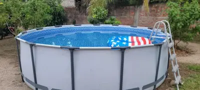 a small pool with an american flag in it at Kinta Mae Foster in Marcelino