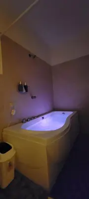 a bathroom with a large tub in a room at Kinta Mae Foster in Marcelino
