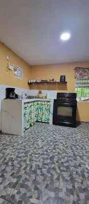 a kitchen with a stove and a counter top at Kinta Mae Foster in Marcelino