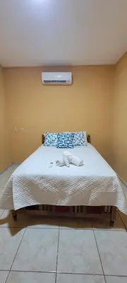 a bedroom with a bed with two shoes on it at Kinta Mae Foster in Marcelino