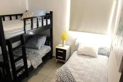 a bedroom with two bunk beds and a small bed at Kailani, Costa del Sol in San Luis La Herradura