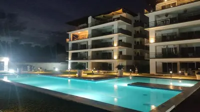 a swimming pool in front of a building at night at Kailani, Costa del Sol in San Luis La Herradura