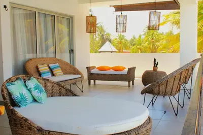 a living room with wicker chairs and a table at Kailani, Costa del Sol in San Luis La Herradura