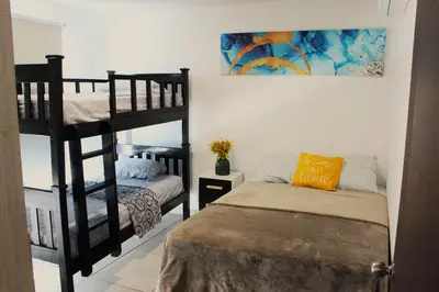 a bedroom with two bunk beds and a bed at Kailani, Costa del Sol in San Luis La Herradura