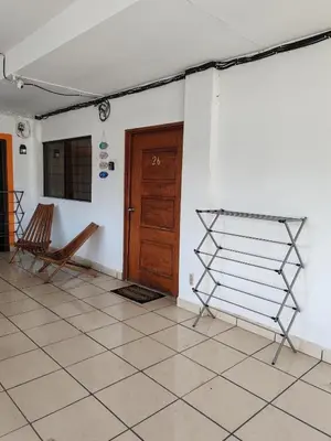 a room with a wooden door and a tiled floor at Cozy Loft,Surf City, La Libertad, in La Libertad