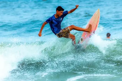 a man riding a wave on a surfboard in the ocean at Cozy Loft,Surf City, La Libertad, in La Libertad