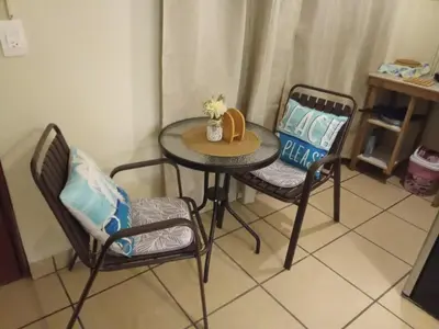 a table with two chairs and a table with flowers on it at Cozy Loft,Surf City, La Libertad, in La Libertad