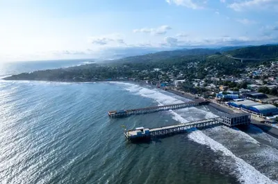 an aerial view of a beach with a pier at Cozy Loft,Surf City, La Libertad, in La Libertad