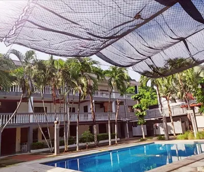 a view of a resort with a swimming pool and palm trees at Cozy Loft,Surf City, La Libertad, in La Libertad