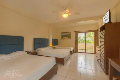 a hotel room with two beds and a ceiling fan at Hotel Roca Sunzal in La Libertad