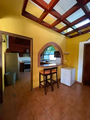 a kitchen with a table in the middle of a room at Casa de Playa en Atami, La Libertad, El Salvador in El Zonte