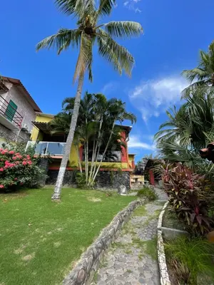 a palm tree in front of a house at Casa de Playa en Atami, La Libertad, El Salvador in El Zonte