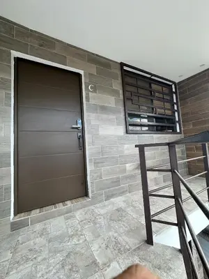 a door in a brick wall next to a table at Apartamento C Fuertevali in San Salvador