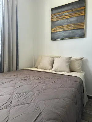 a bed in a room with a picture on the wall at Apartamento C Fuertevali in San Salvador