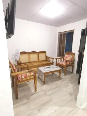 a living room with two benches and a table at Casa céntrica en zona privada in Las Delicias