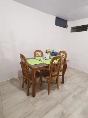 a dining room table with four chairs and a green table at Casa céntrica en zona privada in Las Delicias