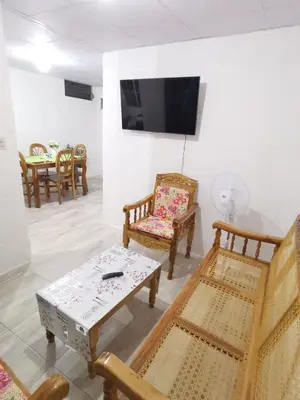a living room with chairs and a table and a tv at Casa céntrica en zona privada in Las Delicias