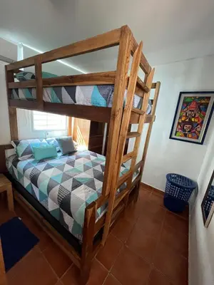 a bunk bed in a room with a bunk bed at Mar y Cielo Beach House in Tamanique